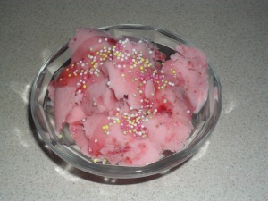 Strawberry Yoghurt Icecream Served with Crab Apple Syrup and Sprinkles